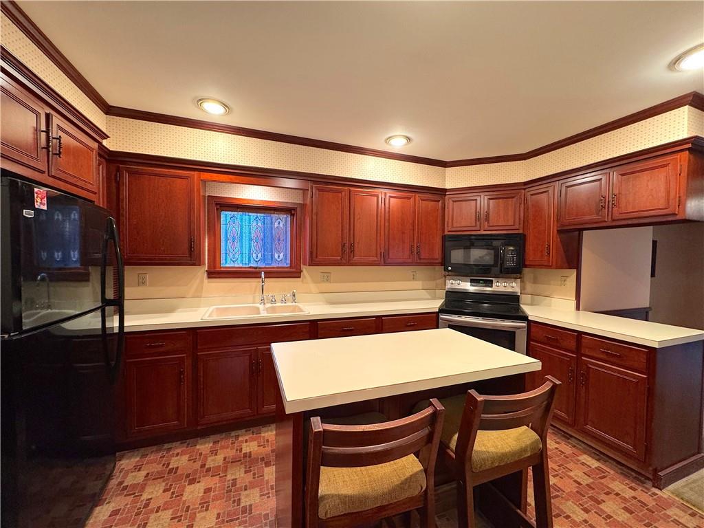 776 Highway 271 Ligonier, PA 15658 - Photo 8 of 29 a kitchen with stainless steel appliances wooden cabinets dining table and chairs