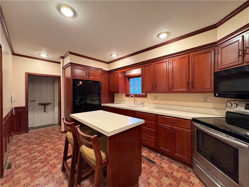 776 Highway 271 Ligonier, PA 15658 - Photo 9 of 29 a kitchen with stainless steel appliances granite countertop a sink stove and refrigerator