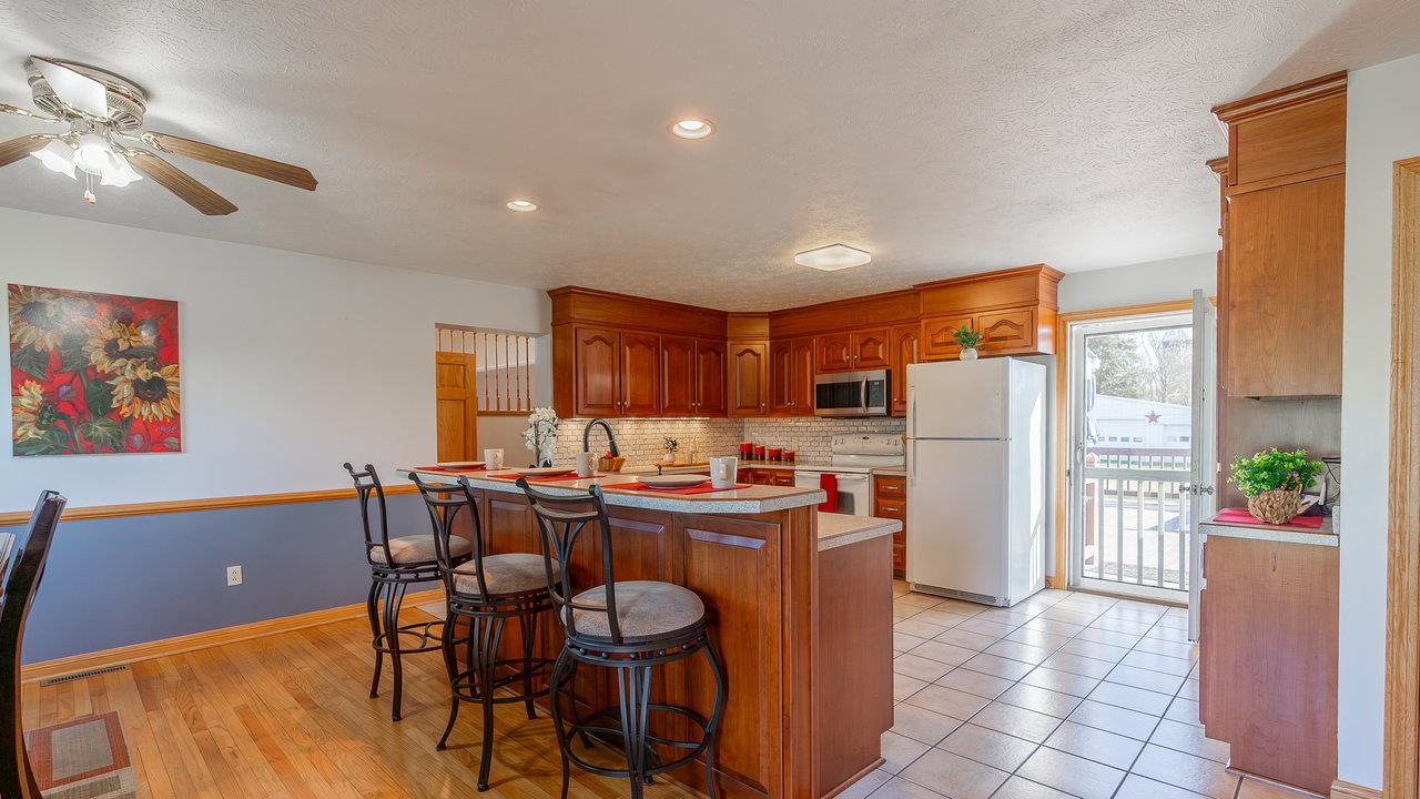 7356 Spring Creek Road Bridgewater, VA 22812 - Photo 10 of 63 a view of a dining room with furniture a kitchen and chandelier