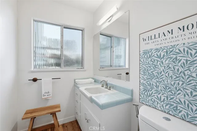 a bathroom with a sink toilet and a mirror