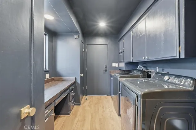 a kitchen that has a sink and cabinets in it
