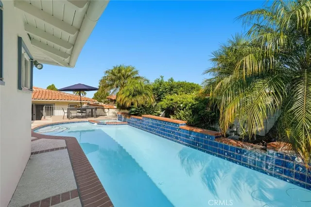 a view of a balcony with plants and palm tree