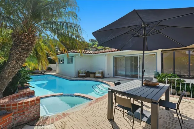 a view of house with backyard and outdoor seating
