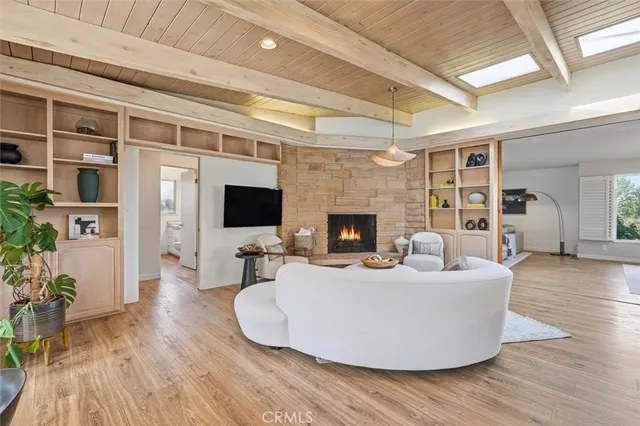 a living room with furniture wooden floor and a flat screen tv