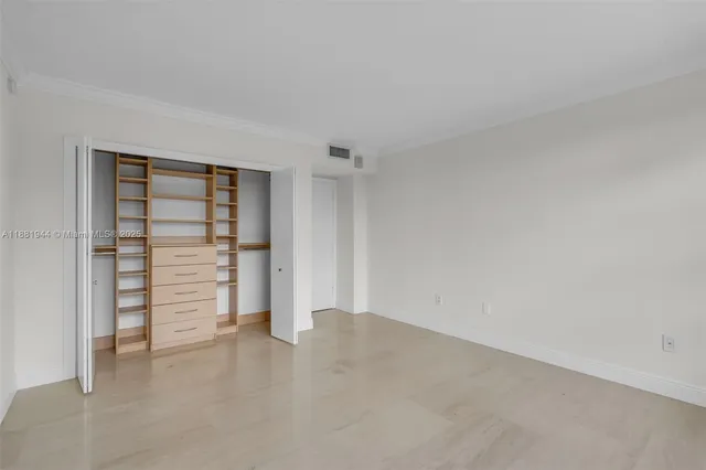 a view of an empty room with a closet
