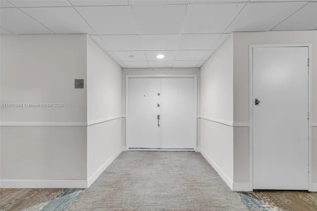 a view of a hallway with white walls