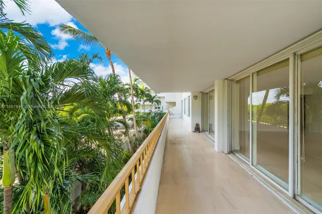 a living room with furniture a large window and white walls