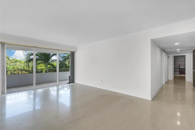 a view of an empty room with a kitchen