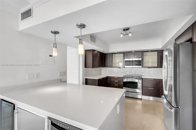 a open kitchen with granite countertop a sink and a stove top oven