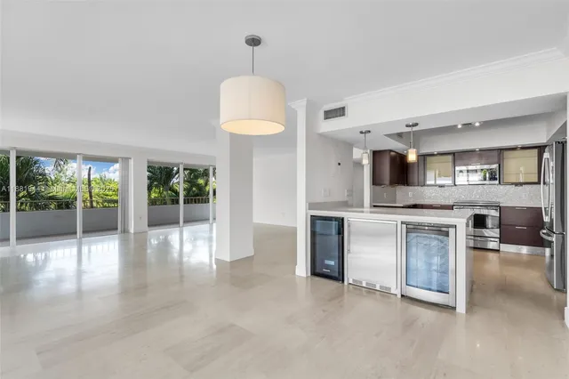 a kitchen with granite countertop a refrigerator and a stove top oven