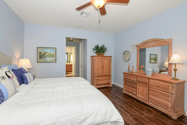 a bathroom with a sink mirror toilet and next to a window