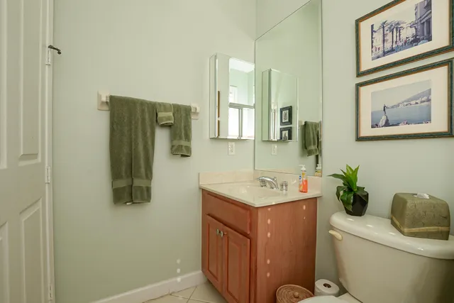 a front view of a house with a garden and plants