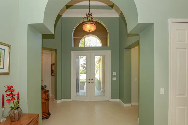 a living room with furniture a couch and a potted plant