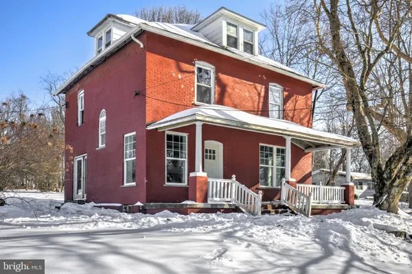 a view of a house with snow on the road