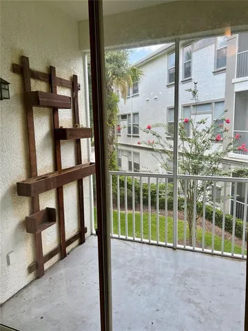 a view of a porch with a floor to ceiling window
