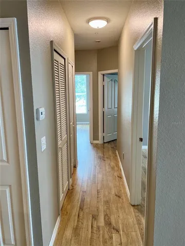 a view of a hallway with wooden floor