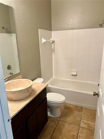 a bathroom with a double vanity sink toilet mirror and shower