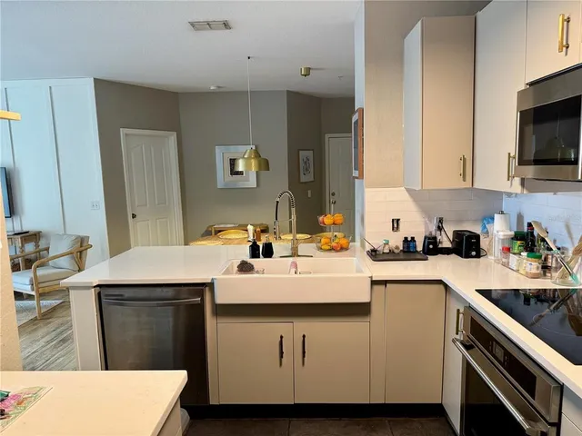 a kitchen with a sink a stove and cabinets