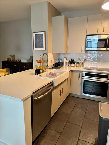 a kitchen with a sink appliances and cabinets