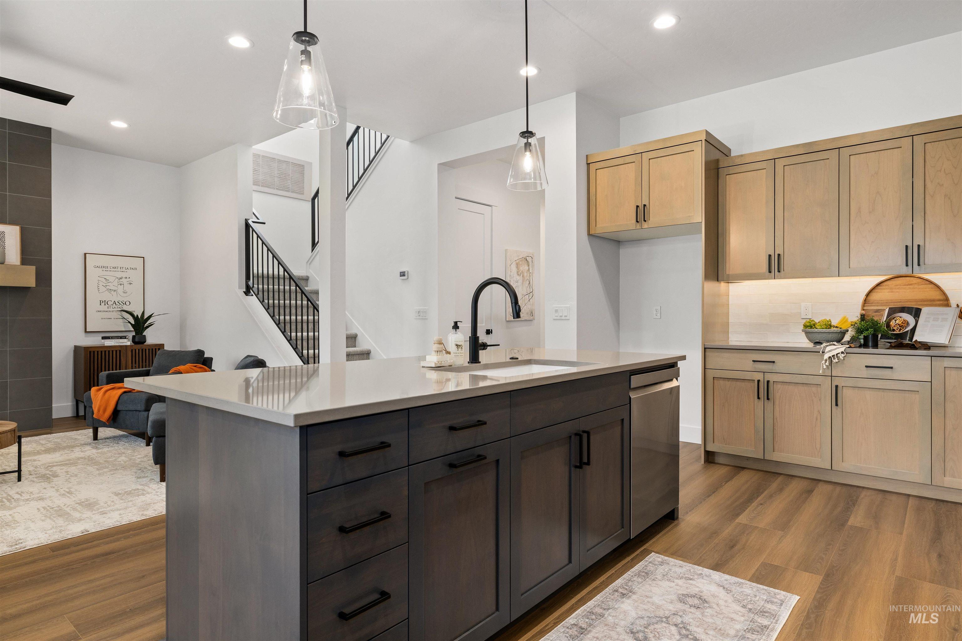 611 North Hiltonhead Way Eagle, ID 83616 - Photo 17 of 38 Kitchen featuring pendant lighting, dark wood-style floors, a kitchen island with sink, stainless steel dishwasher, and recessed lighting