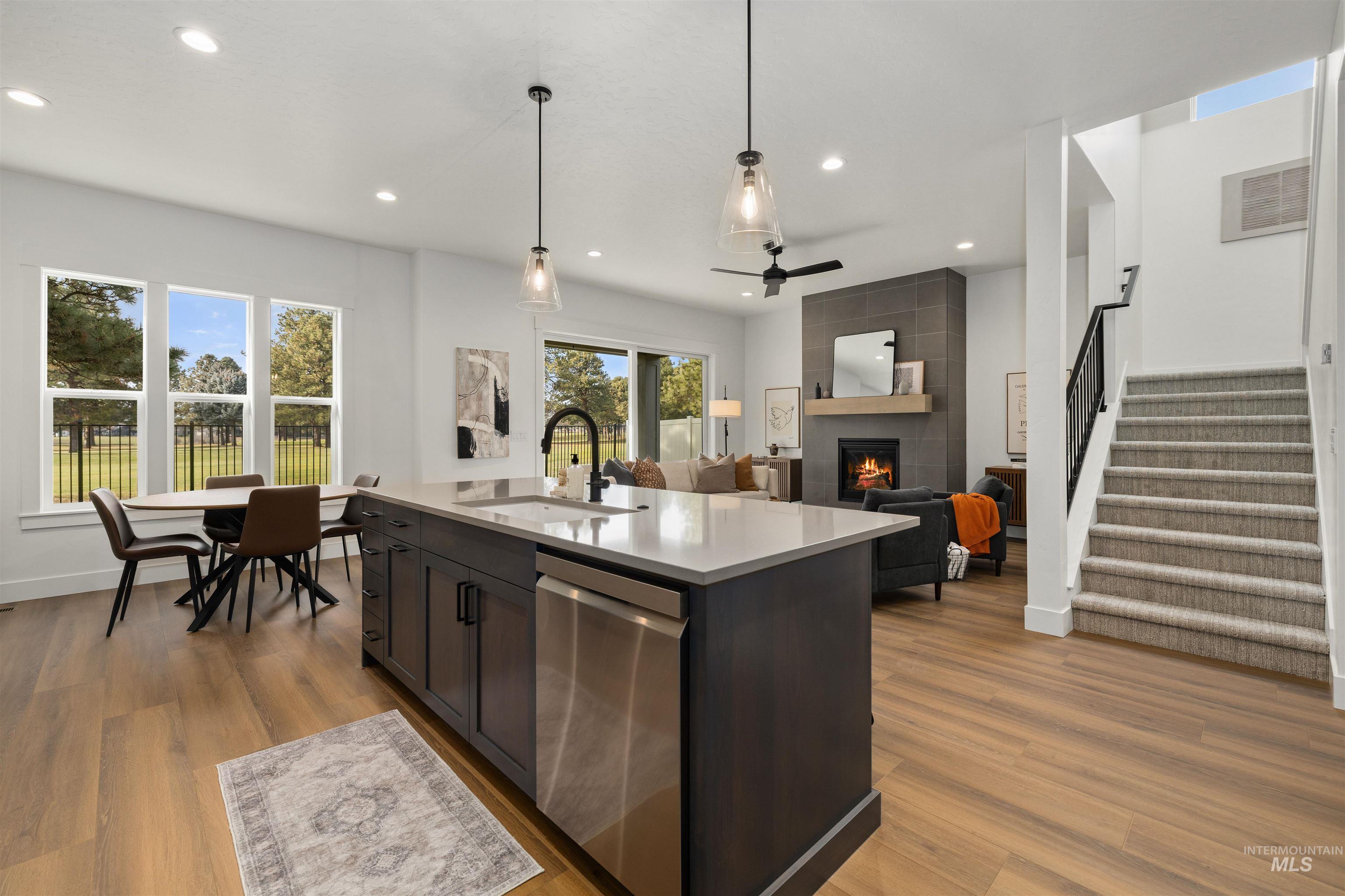 611 North Hiltonhead Way Eagle, ID 83616 - Photo 18 of 37 Kitchen featuring dishwasher, a fireplace, light wood finished floors, pendant lighting, and recessed lighting. Photo Similar.