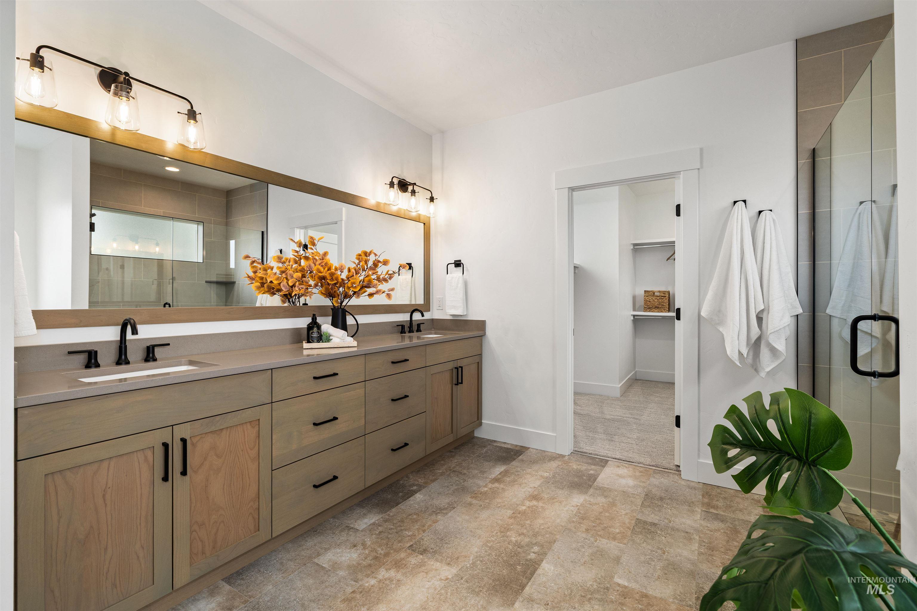 611 North Hiltonhead Way Eagle, ID 83616 - Photo 26 of 38 Bathroom with a stall shower, double vanity, and a walk in closet