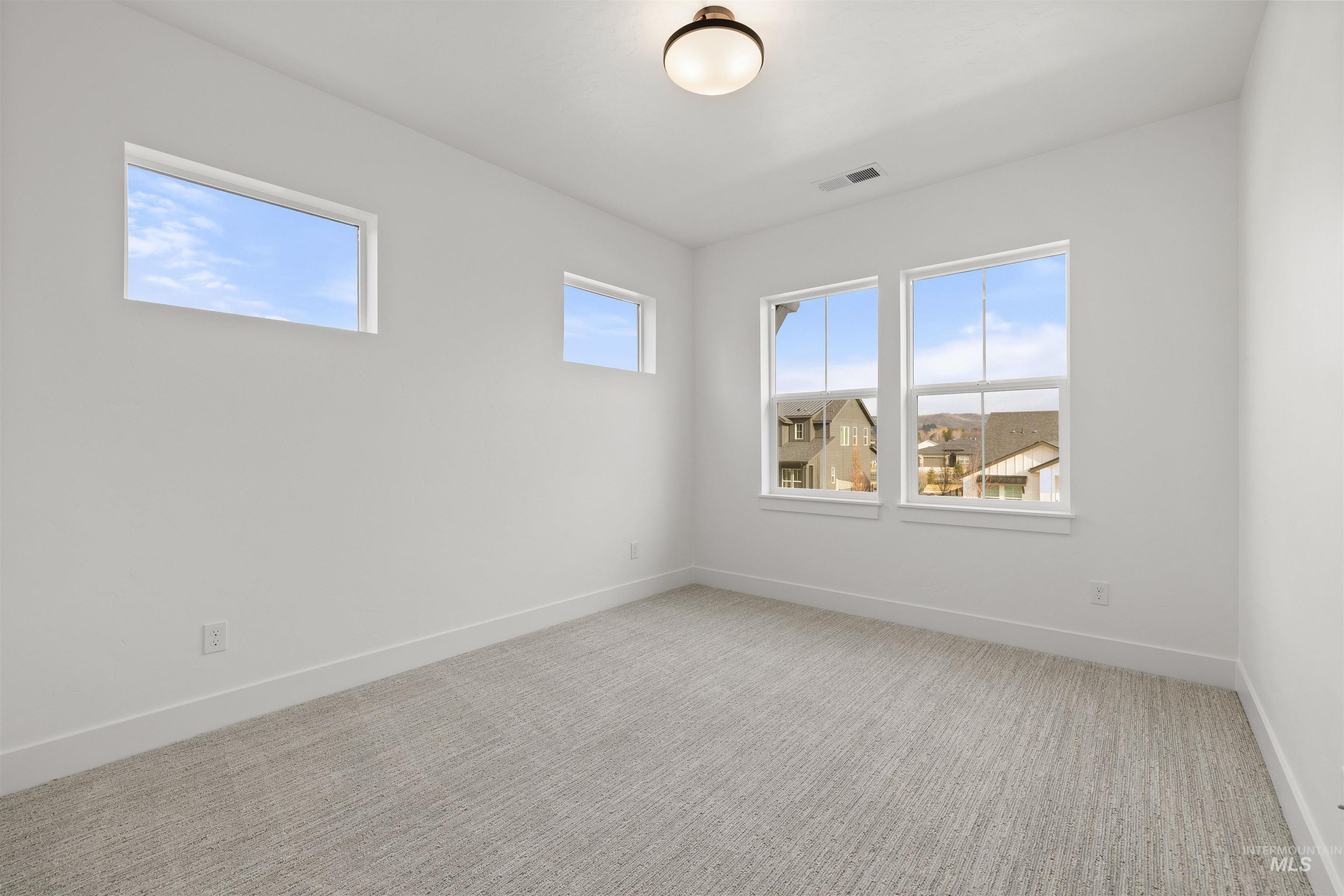 611 North Hiltonhead Way Eagle, ID 83616 - Photo 29 of 37 Spare room featuring carpet floors and baseboards. Photo Similar.