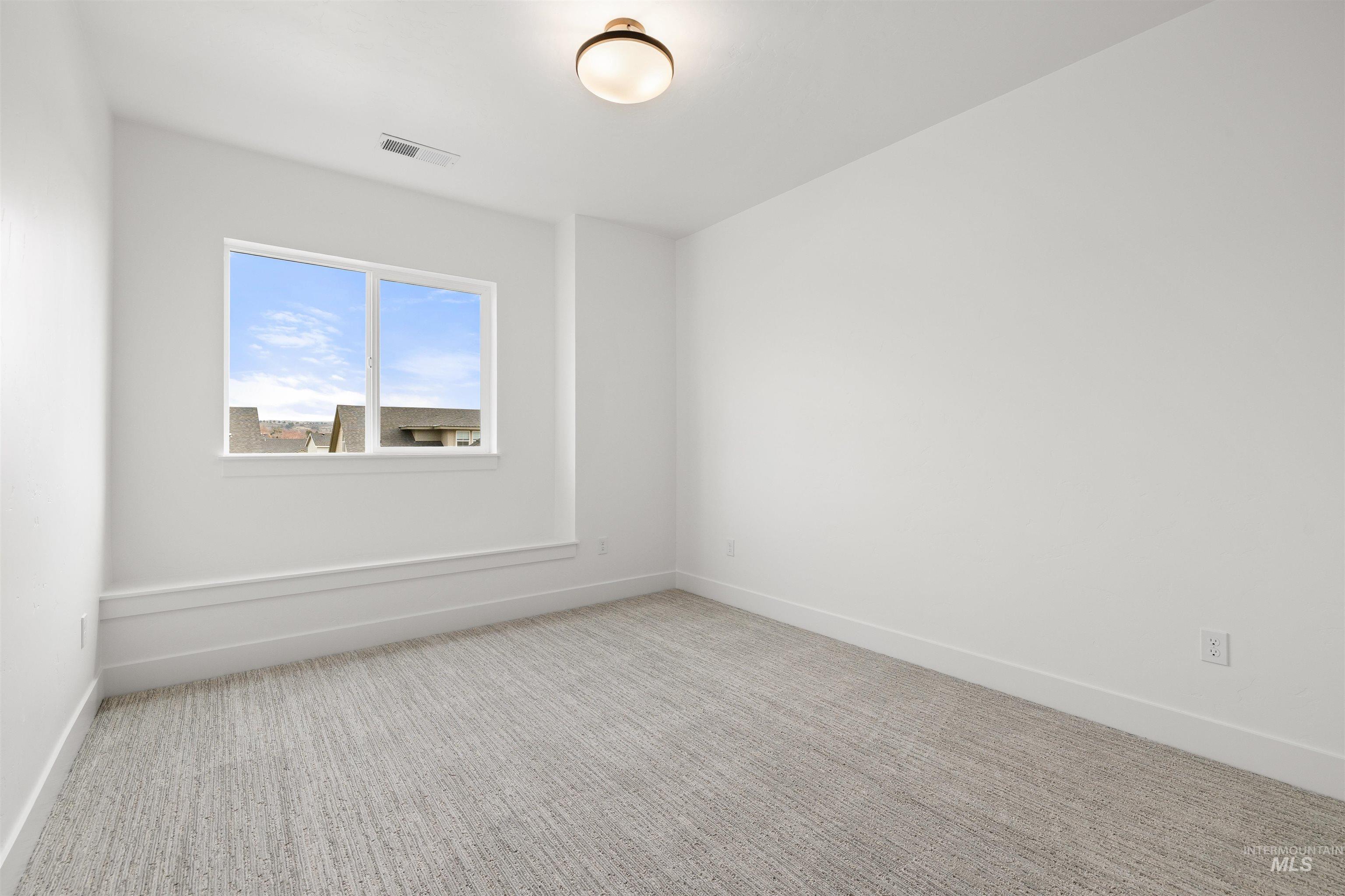 611 North Hiltonhead Way Eagle, ID 83616 - Photo 31 of 37 Unfurnished room featuring light colored carpet and baseboards. Photo Similar.