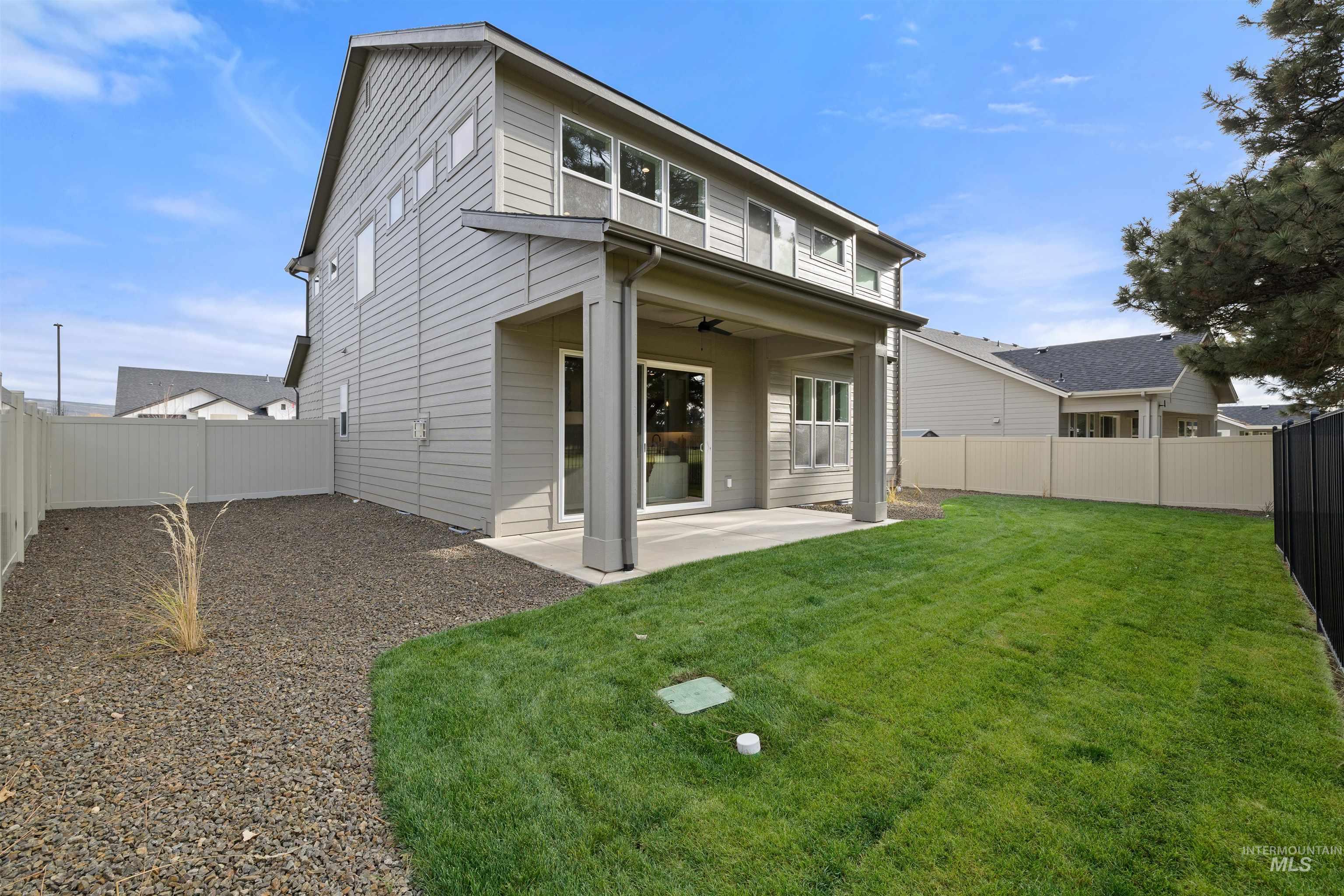 611 North Hiltonhead Way Eagle, ID 83616 - Photo 35 of 37 Rear view of property featuring a patio area, a fenced backyard, and ceiling fan. Photo Similar.