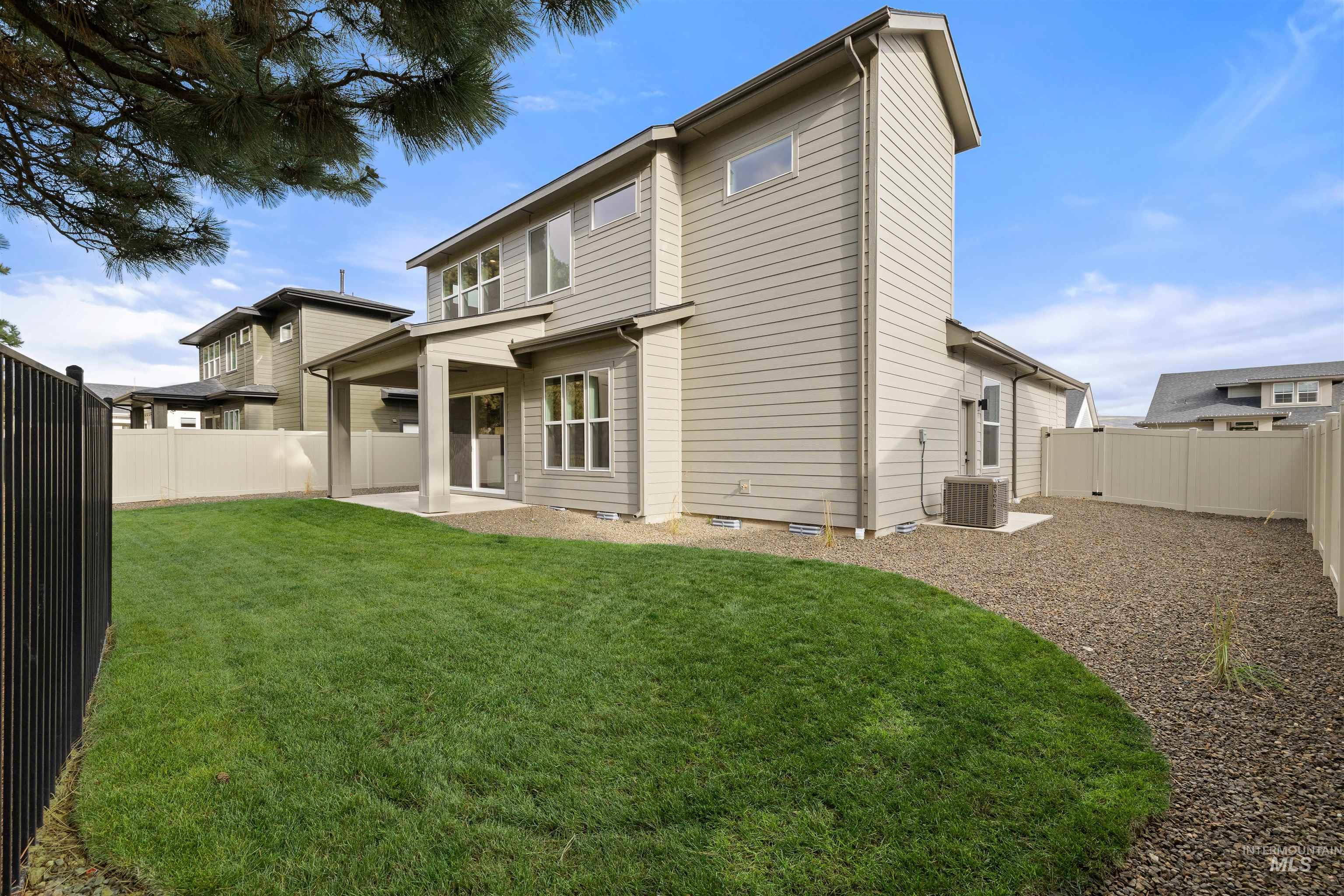 611 North Hiltonhead Way Eagle, ID 83616 - Photo 35 of 38 Back of house featuring a patio area and a fenced backyard