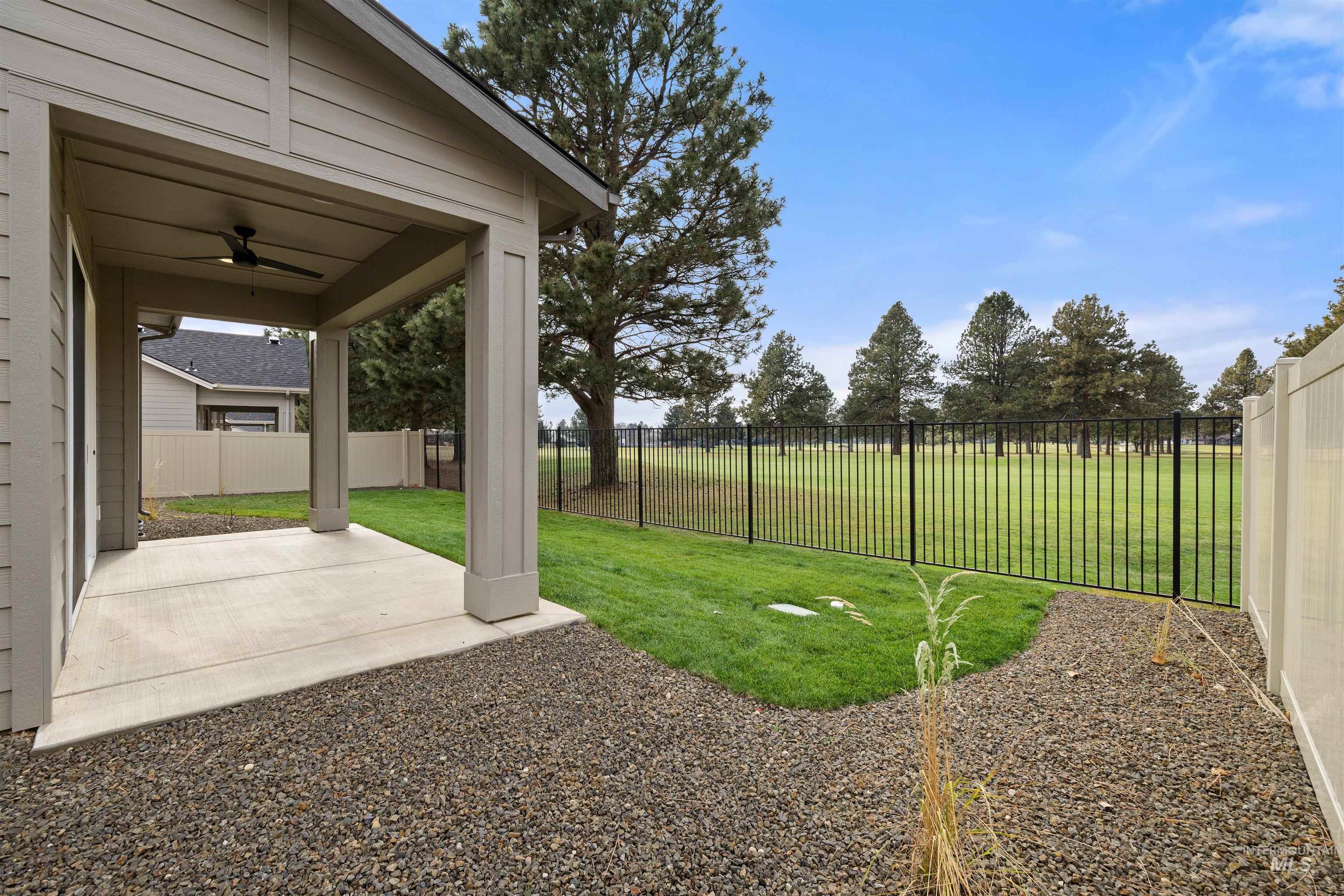 611 North Hiltonhead Way Eagle, ID 83616 - Photo 36 of 37 Fenced backyard featuring a patio area and a ceiling fan. Photo Similar.