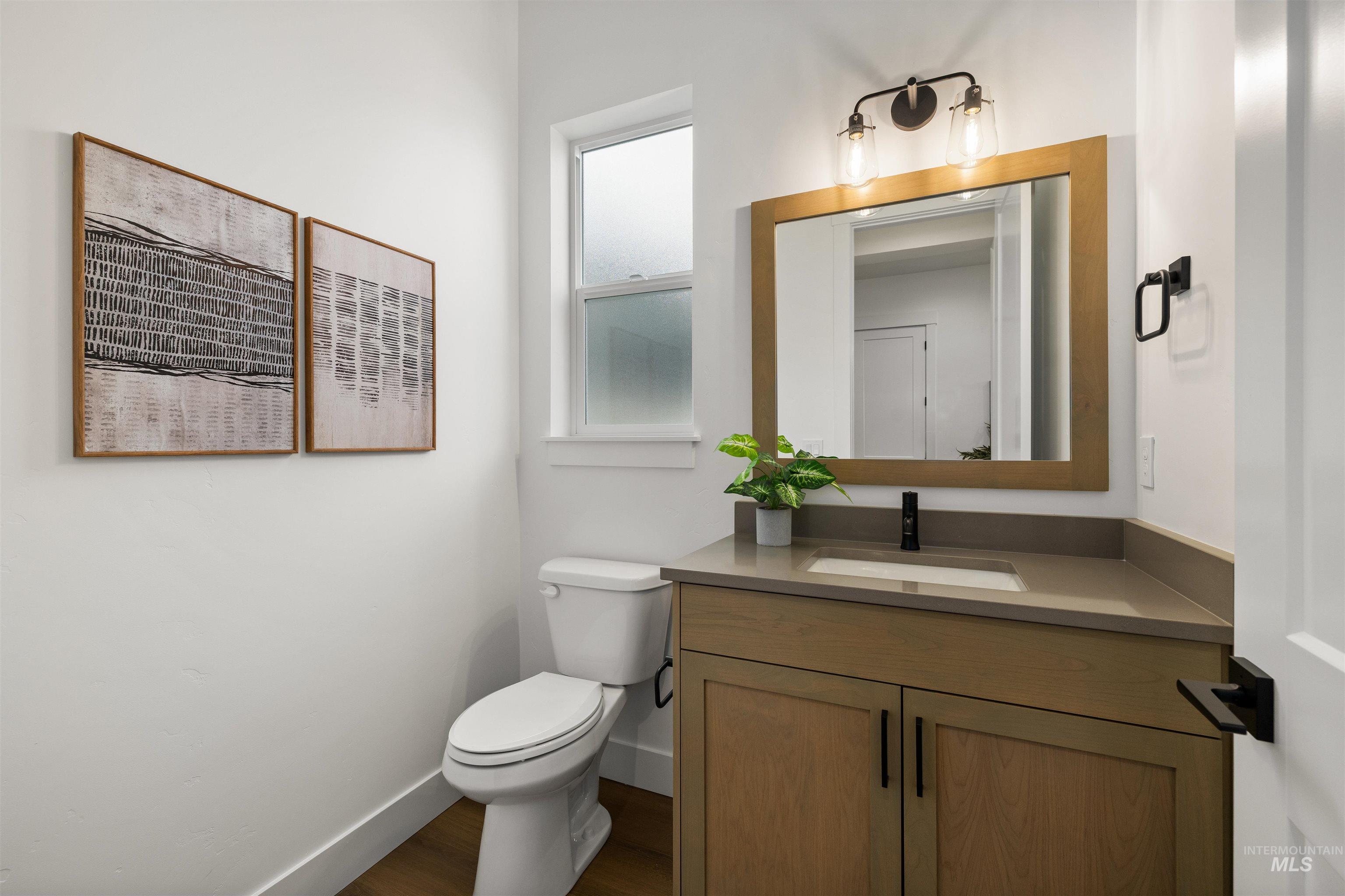 611 North Hiltonhead Way Eagle, ID 83616 - Photo 6 of 38 Half bath featuring vanity and dark wood-type flooring