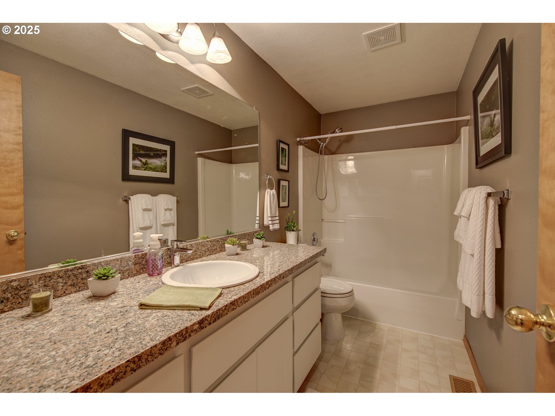212 Northeast 148th Avenue Portland, OR 97230 - Photo 16 of 23 a bathroom with a granite countertop sink toilet a mirror a vanity and shower