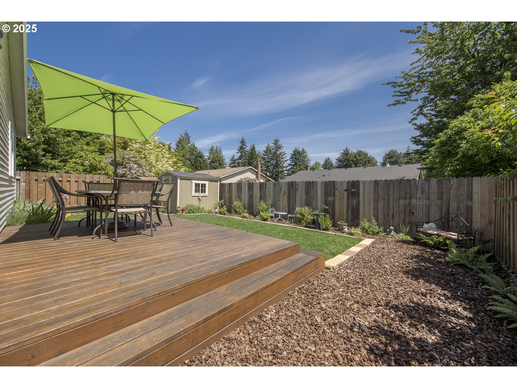 212 Northeast 148th Avenue Portland, OR 97230 - Photo 22 of 23 a view of a backyard with a table and chairs under an umbrella
