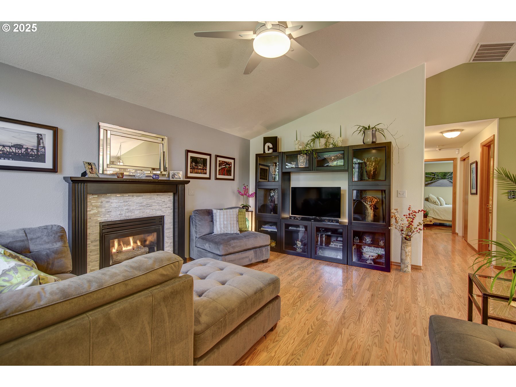 212 Northeast 148th Avenue Portland, OR 97230 - Photo 5 of 23 a living room with furniture a flat screen tv and a fireplace