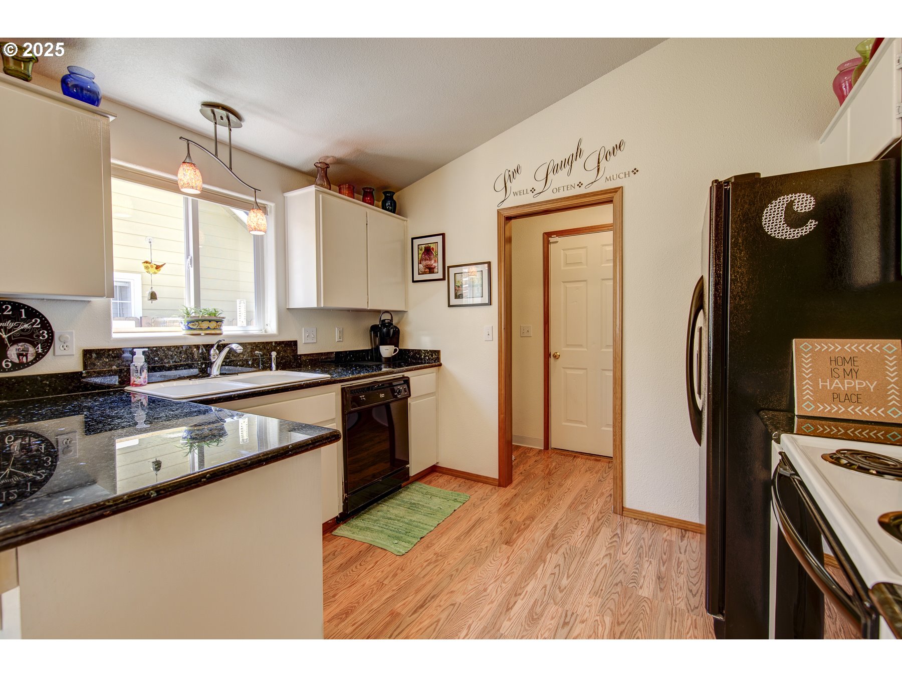 212 Northeast 148th Avenue Portland, OR 97230 - Photo 7 of 23 a kitchen with a refrigerator and a sink