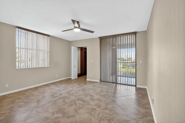 an empty room with a empty space and windows