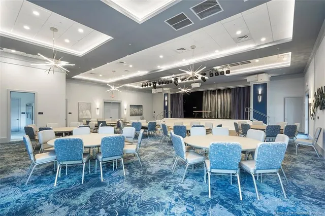 a large white kitchen with a dining table and chairs