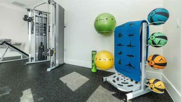 a view of a bedroom with gym equipment