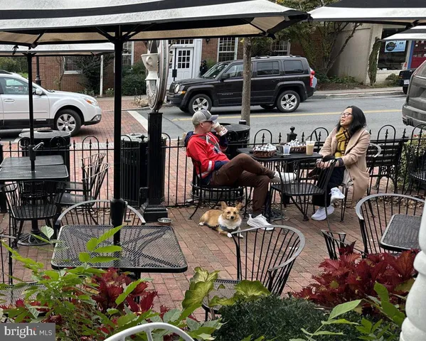 a front view of a house with outdoor seating