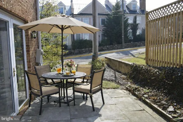 a view of an outdoor dining space with a patio