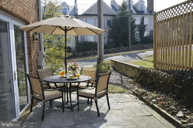 a view of an outdoor dining space with a patio