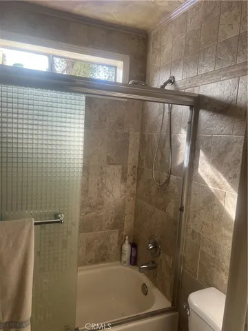 a bathroom with a shower and a toilet