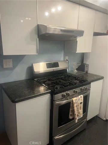 a stove top oven sitting inside of a kitchen