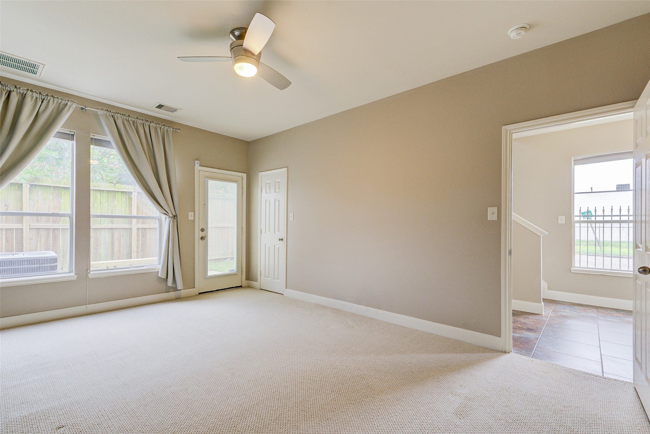 3129 Dallas Street Houston, TX 77003 - Photo 5 of 24 an empty room with windows and ceiling fan
