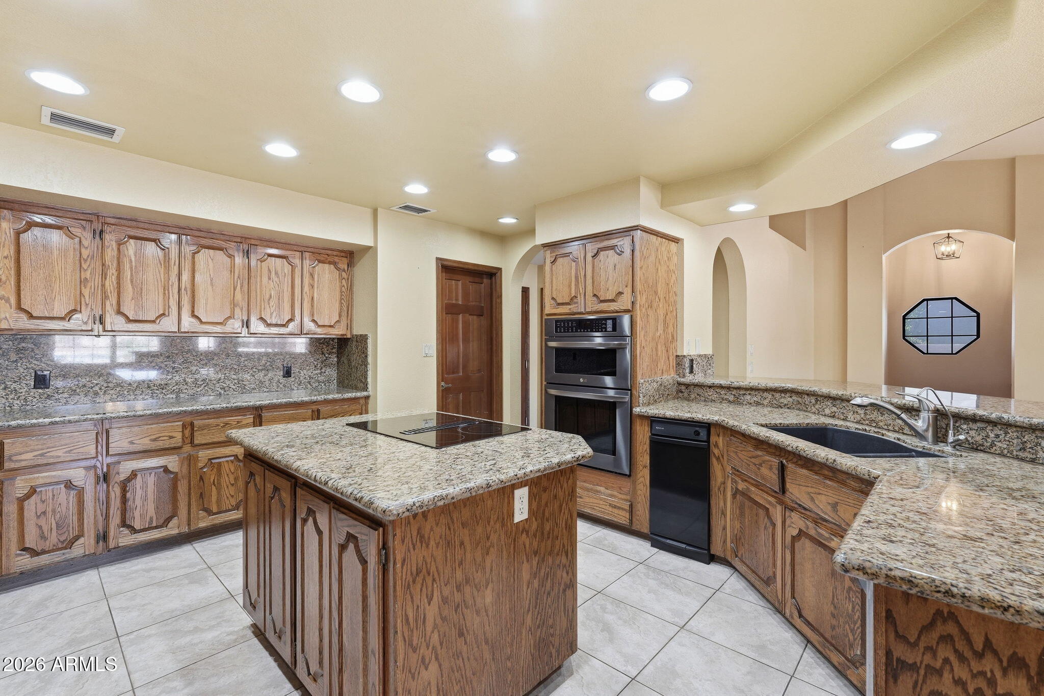602 East Carver Road Tempe, AZ 85284 - Photo 20 of 85 a kitchen with stainless steel appliances granite countertop a stove a sink dishwasher and a refrigerator