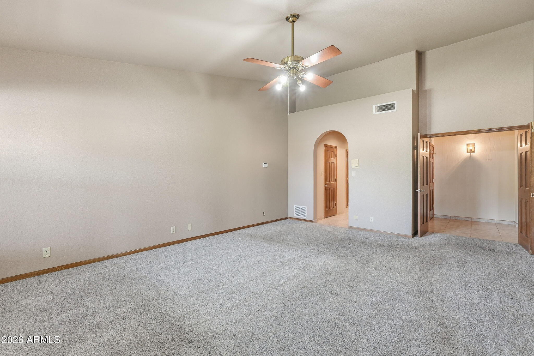 602 East Carver Road Tempe, AZ 85284 - Photo 24 of 85 an empty room with a chandelier fan and a large window
