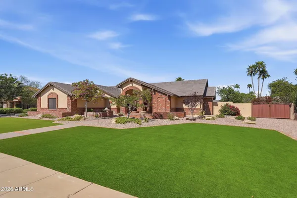 a front view of a house with swimming pool garden and outdoor seating