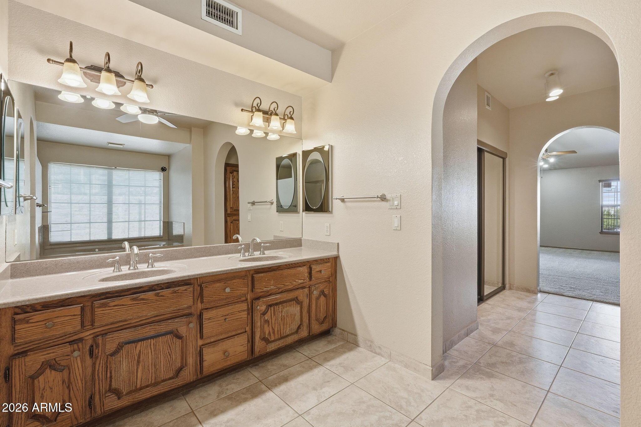 602 East Carver Road Tempe, AZ 85284 - Photo 30 of 85 a spacious bathroom with a double vanity sink and a mirror