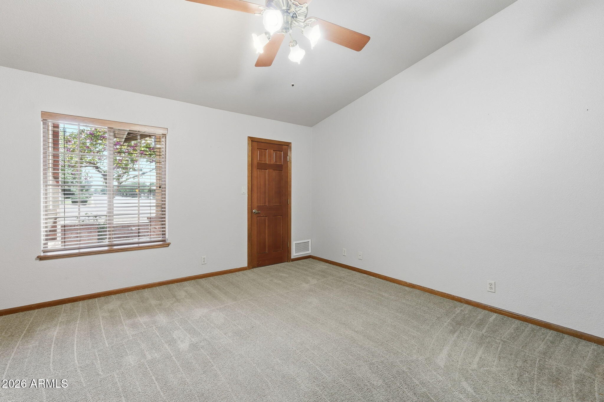 602 East Carver Road Tempe, AZ 85284 - Photo 34 of 85 an empty room with a chandelier fan and windows